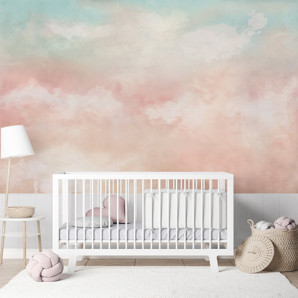Airy cloudscape mural with broad, feathered cloud forms in mint and blush tones, blending seamlessly into a washed ground. Perfect for creating a spacious and calming atmosphere in bedrooms or living rooms. The high-quality, self-adhesive wallpaper is easy to apply and reposition, making it an excellent choice for renters.