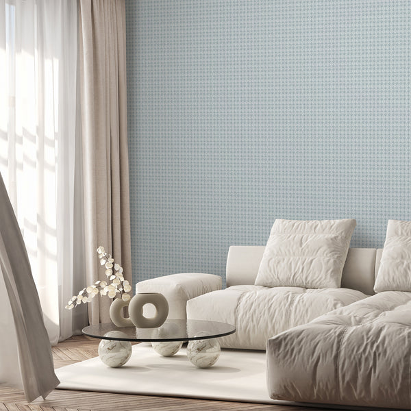 Distressed dusty blue damask wallpaper featuring delicate repeating floral motifs and subtle aged texture for a bedroom accent wall or powder room.