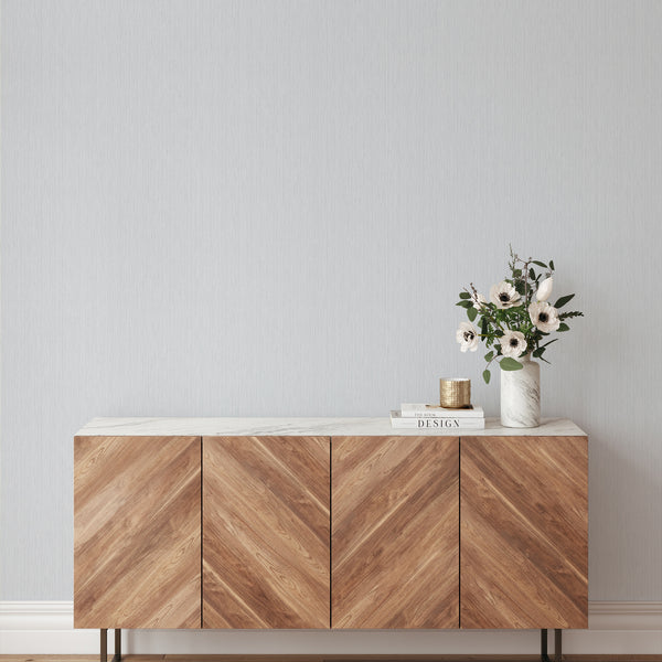 Light Blue Vertical Texture Wallpaper with a continuous vertical pattern of fine lines on a pale blue-gray ground. This temporary, self-adhesive wallpaper suits Japandi living rooms, providing a clean, tailored aesthetic that enhances the room's height while being ideal for renters and designers.