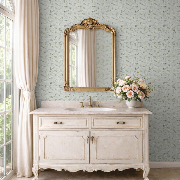 Floral vine wallpaper with delicate sage green vine sprigs on a pale, linen-effect ground. The petite scale and subtle texture offer a cozy, traditional look, ideal for dining rooms or bedrooms. This high-quality removable wallpaper is easy to apply and reposition, offering a versatile and temporary decor solution.