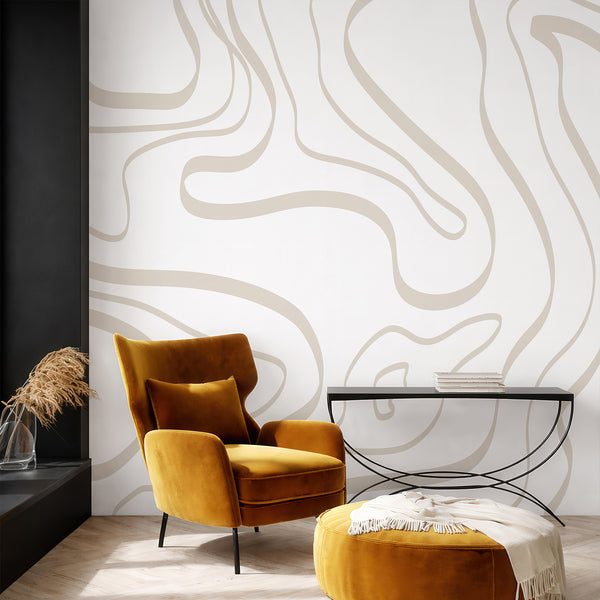 Minimalist beige wallpaper featuring large freeform curved lines on a soft white background for a modern bedroom or living room interior.