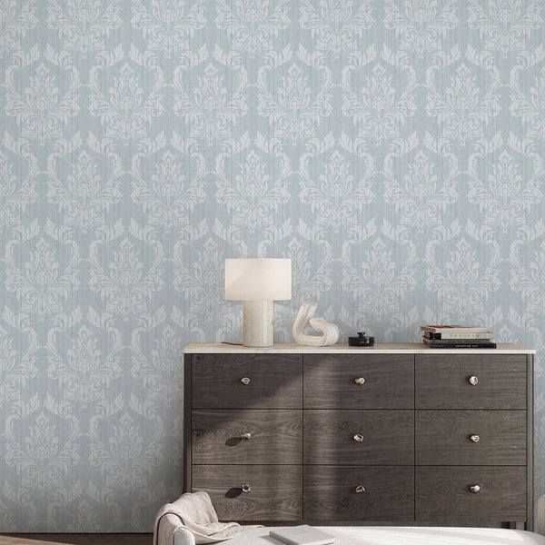 Classic Blue Damask wallpaper with soft white floral ornaments over a pale blue ground. Its vintage feel and refined texture make it suitable for welcoming hallways or stylish living rooms. The statement wall mural is easy to reposition, ideal for those seeking a sophisticated touch in their home decor, made in the USA with high-quality materials.