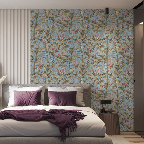 Vintage parrot wallpaper with green tropical birds, pink flowers, leaves and layered botanical plants against a muted blue background.