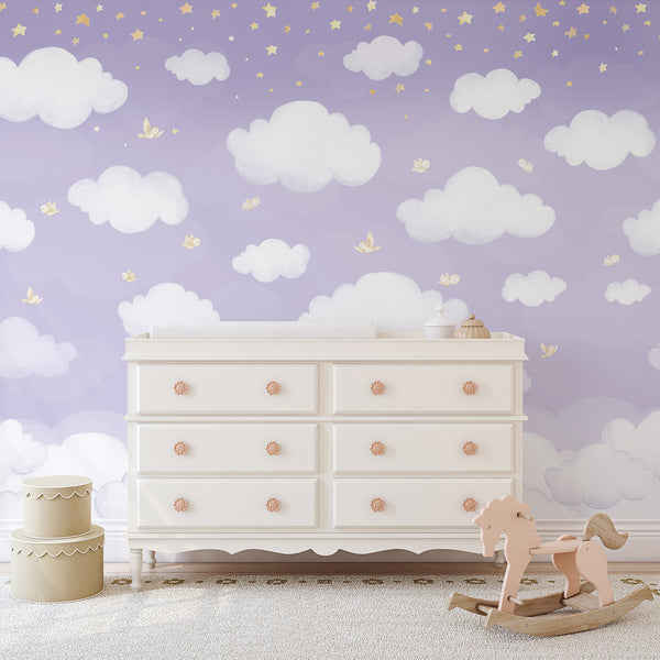 Lavender cloud nursery wall mural featuring soft white watercolor clouds, tiny yellow stars and delicate flying birds across a dreamy purple sky.