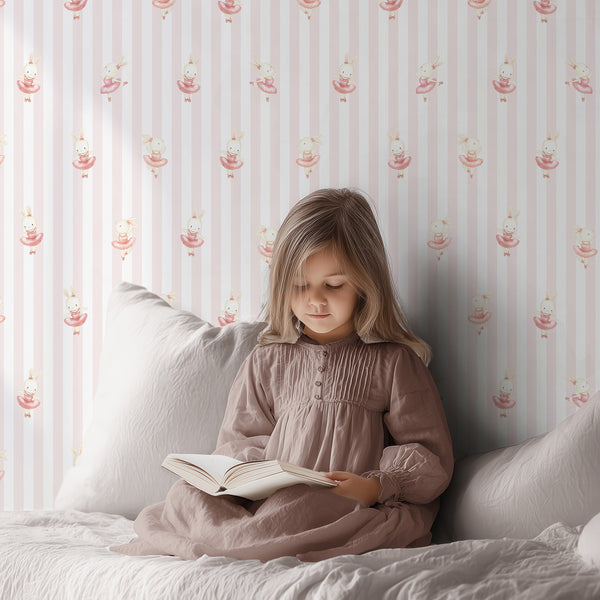 Watercolor rabbit ballerina wallpaper with blush pink vertical stripes, creating a charming coquette look for a girls bedroom or nursery.