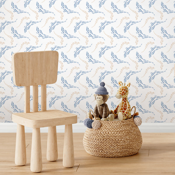 Sea life wallpaper featuring blue fish in different sizes with sandy beige fish schools for a coastal kids room or beach house bedroom.