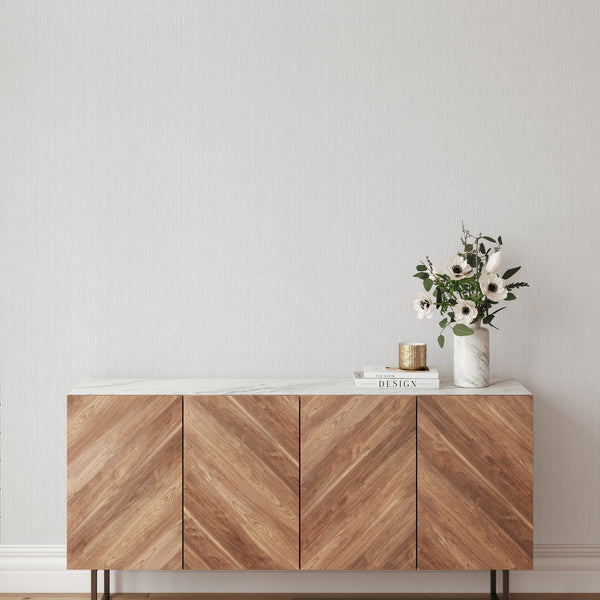 The Light Gray Vertical Texture Wallpaper offers a smooth, tailored appearance with its pale warm gray ground and thread-like lines. This self-adhesive wallpaper is perfect for creating a stylish, contemporary look in minimalist bedrooms or living rooms, with easy application for decorators.