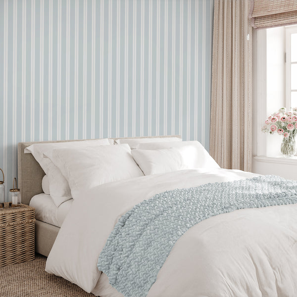 Light blue striped wallpaper with clean white bands and delicate vertical lines, ideal for coastal interiors, nursery walls, or modern bedroom decor.