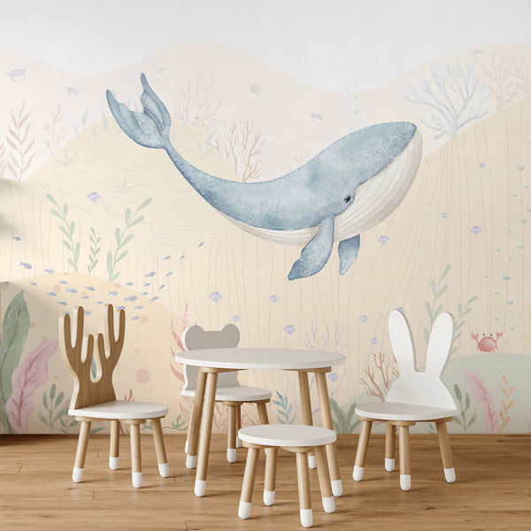 Sea life wallpaper with a large blue whale, tiny schools of fish, coral, crab, bubbles, and aquatic plants in pale blue, beige, pink, and green tones.
