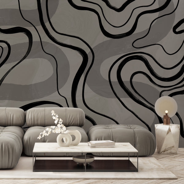 Modern line art wallpaper with bold black organic curves across a soft gray textured background, perfect for a living room accent wall.