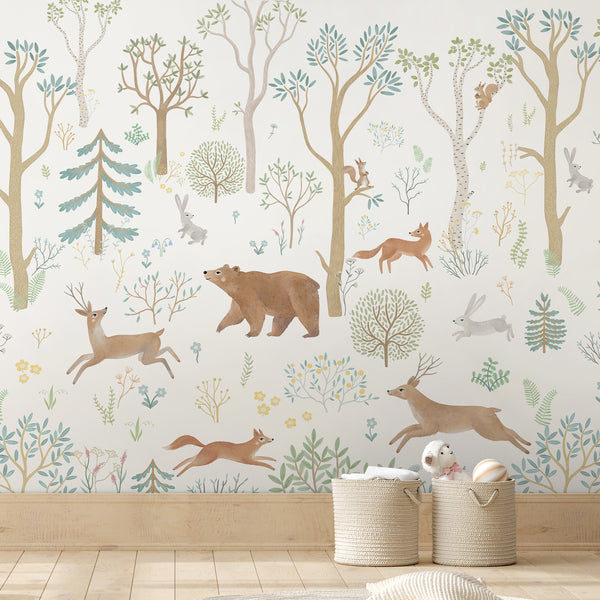 Woodland wall mural with illustrated animals, birch trees, and wildflowers in soft, muted colors, creating a panoramic, storybook scene. Perfect for children's bedrooms or Scandinavian-style playrooms, this pre-pasted wallpaper provides a seamless, high-quality finish. Made in the USA, it is an eco-friendly choice for temporary wall murals.