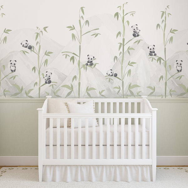 Panda nursery wallpaper with playful watercolor pandas sitting on bamboo branches among pale green leaves and soft gray beige mountain scenery.