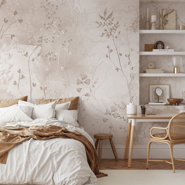 Beige botanical wallpaper with delicate wildflowers, leafy stems and soft watercolor layers in warm neutral tones for a modern bedroom accent wall.