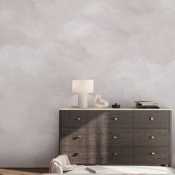 Neutral pink cloud wallpaper featuring delicate cloud formations and a dreamy pastel sky, creating a soft backdrop for nursery and bedroom decor.