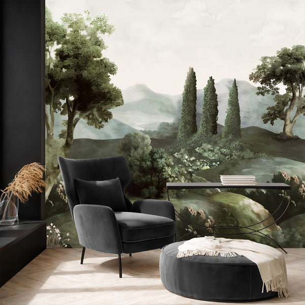 Moody landscape wallpaper in dark green and muted gray tones with tall trees, rolling countryside, misty mountains, and painterly botanical scenery.