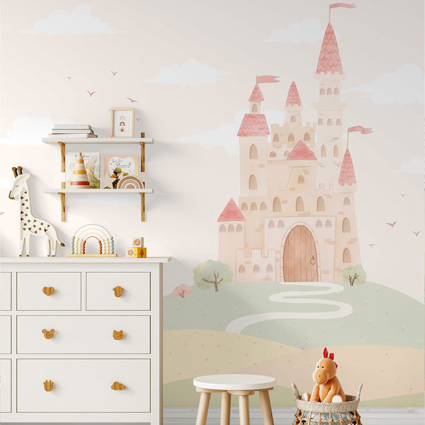 Princess nursery wallpaper mural featuring a pastel pink castle surrounded by rolling green and peach hills, white clouds and a whimsical countryside.