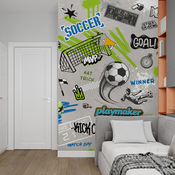 Dynamic soccer-themed graffiti mural with layered elements, including sketchy soccer motifs and bold stencil splashes. The high-contrast colors create a lively atmosphere, perfect for a game room or playroom. This self-adhesive mural is easy to apply, reposition, and remove.