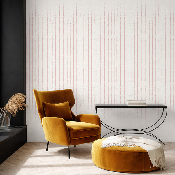 Close-up of dusty pink stripe wallpaper showing irregular hand-drawn strokes that bring a relaxed rhythm to home offices and hallways.