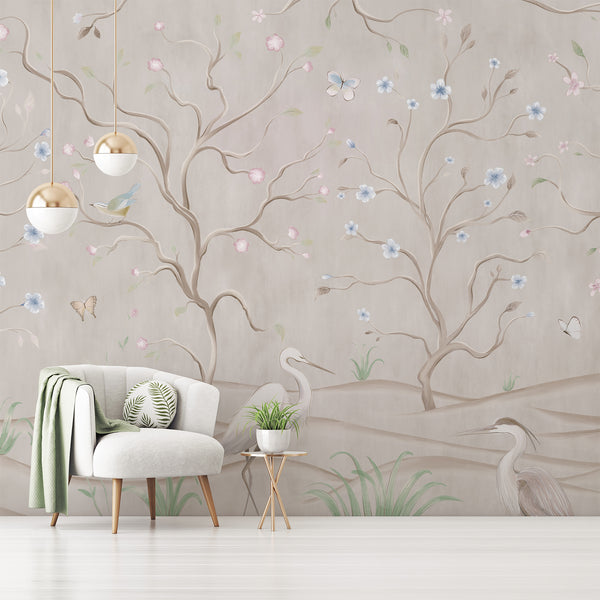 Pastel botanical wall mural with graceful heron birds, winding branches, delicate pink and blue flowers and butterflies on a warm neutral beige background.