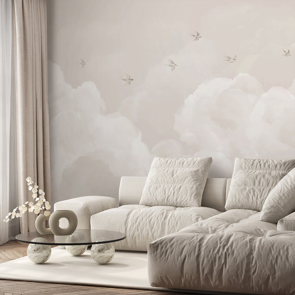 Beige sky wallpaper with large soft white clouds and subtle illustrated birds, creating an airy minimalist backdrop for a nursery or kids room.