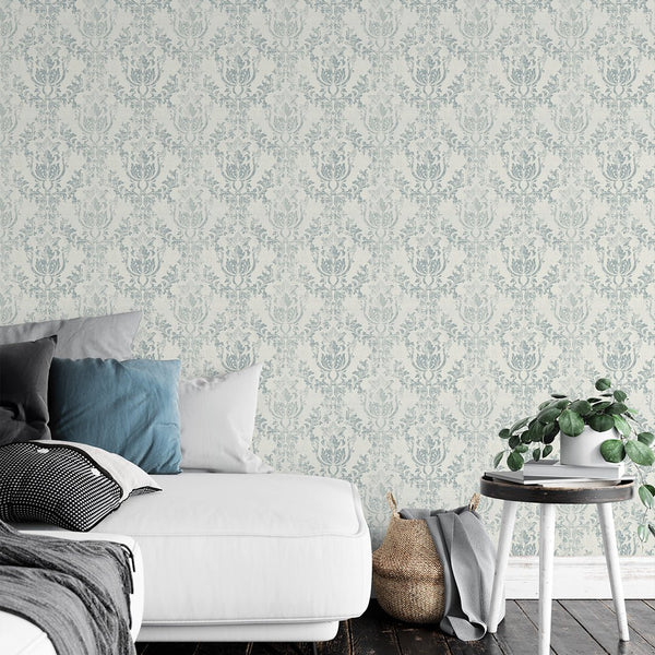 Light Blue Rococo wallpaper with faded rococo cartouches on a warm ivory background. The lightly distressed finish is ideal for a vintage-inspired hallway or bedroom, offering a classic decor touch with easy application.
