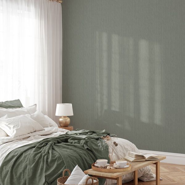 Close-up of dense vertical striations in muted sage green, mimicking grasscloth texture for home office walls.