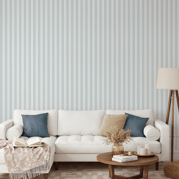 Soft blue pinstripe wallpaper featuring crisp white vertical stripes and fine linear accents for a minimalist nursery or bedroom accent wall.