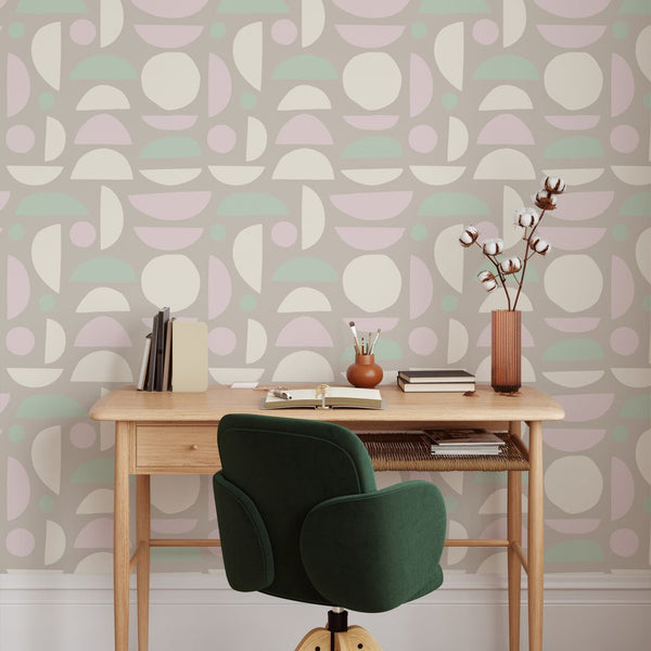 Modern geometric wallpaper with pastel mint, pink, and taupe circles and semicircles. Suitable for hallways or nurseries, this removable peel and stick design is crafted from high-quality materials, providing a playful yet orderly accent for contemporary interiors.