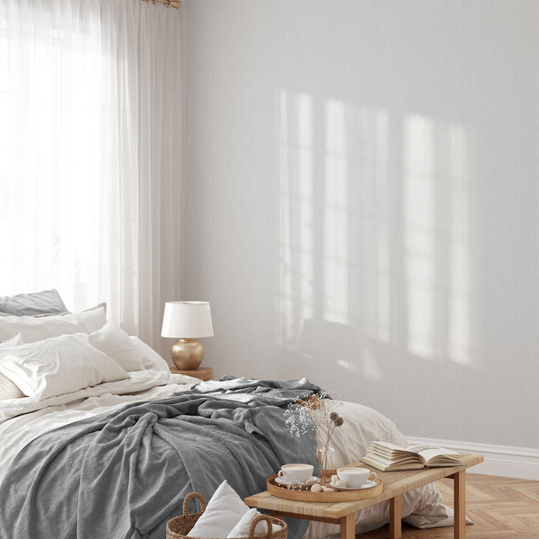 Close-up of Light Gray Vertical Texture Wallpaper, showcasing its subtle striations and warm gray tones. Perfect for a modern, neutral backdrop in living rooms or bedrooms, this traditional unpasted wallpaper is easy to apply and reposition, making it ideal for renters.
