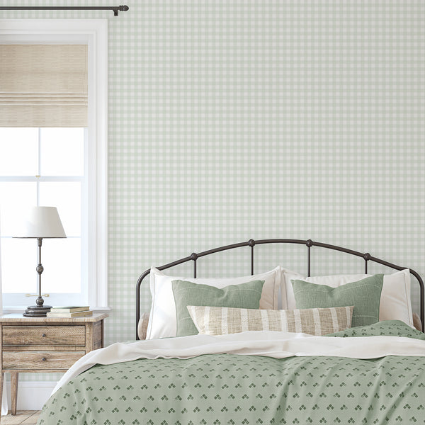 Farmhouse checkered wallpaper in muted sage green and white with fine linear texture for a cozy cottage bedroom or nursery accent wall.