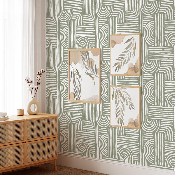 Close-up of Green Boho Wallpaper's large-scale pattern showcasing concentric semicircles and horizontal stripes in white brush strokes over sage green. Ideal for a home office or hallway, this eco-friendly, self-adhesive wallpaper adds a modern aesthetic to interiors without overpowering the space.