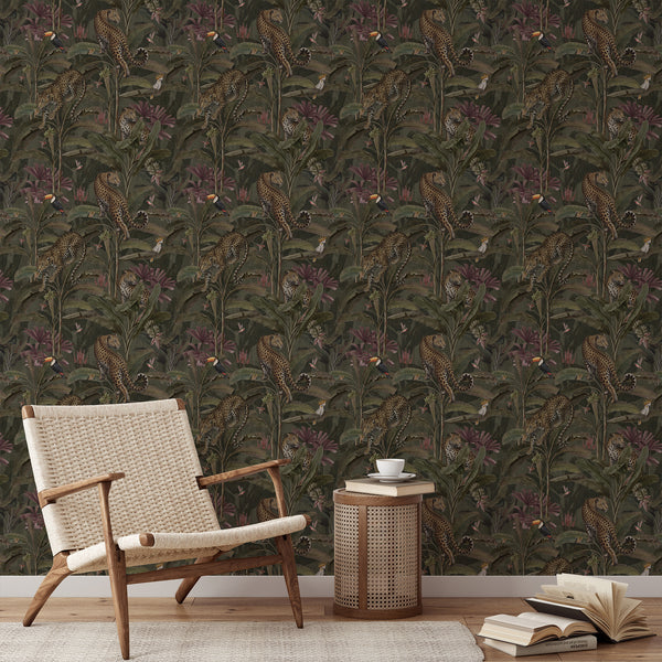 Vintage tropical animal wallpaper with leopards resting among dense jungle plants, muted olive leaves and colorful birds on a dark green background.