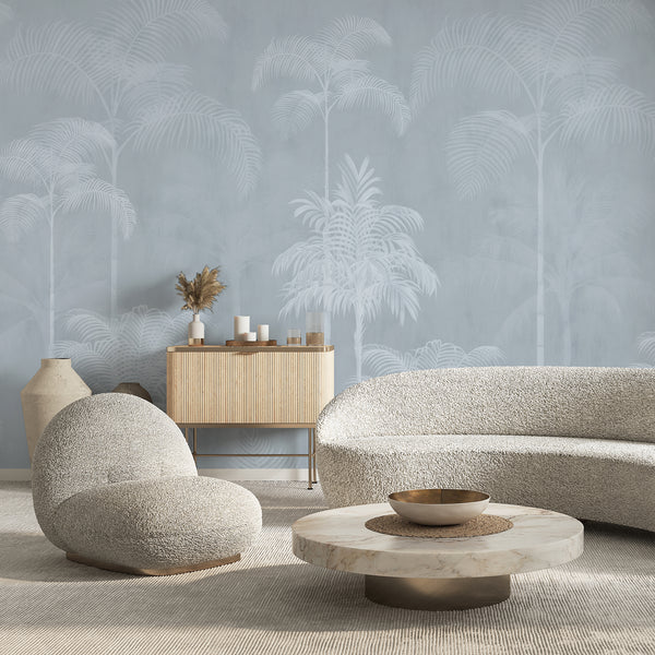 Neutral blue palm tree wallpaper with an airy tropical landscape of tall palms and delicate foliage for a modern living room accent wall.
