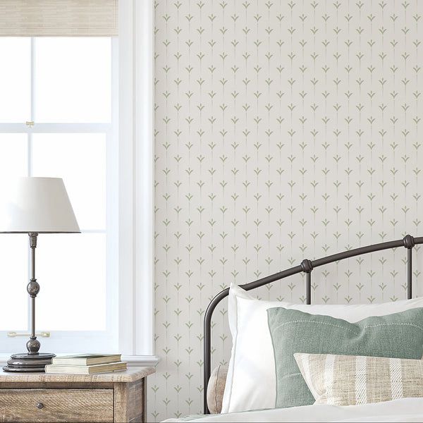 Sage green minimalist wallpaper featuring small stylized botanical motifs and delicate dotted vertical stems on a warm beige background.