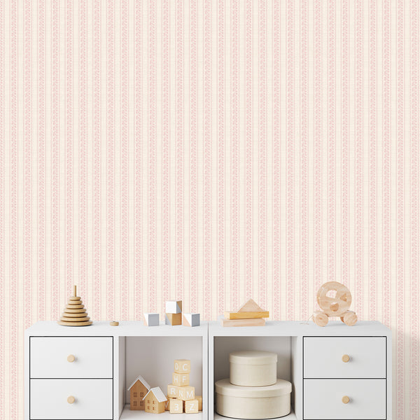 Nursery wallpaper in soft blush pink featuring delicate botanical flowers, vertical stripe columns, and a charming cottagecore aesthetic for children's rooms.