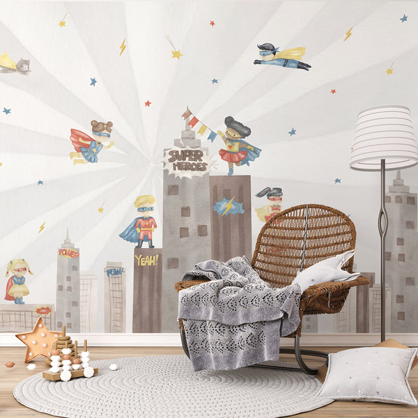 Superhero kids room wall mural with watercolor boys and girls flying above a city skyline in soft red, blue, yellow, gray, and white tones.