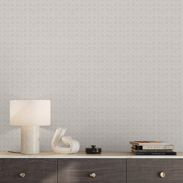 Neutral beige botanical wallpaper featuring repeating damask floral motifs with a faded textured finish, ideal for a bedroom or living room accent wall.