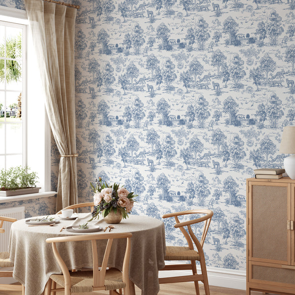 Detailed scenic toile wallpaper in blue, showcasing wildlife and architectural motifs on a white ground, perfect for creating a traditional statement wall in living rooms. The removable, self-adhesive design is ideal for decorators seeking a classic aesthetic.