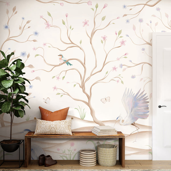 Chinoiserie wall mural with graceful herons, pastel pink and blue flowers, twisting branches and birds against a clean white background.