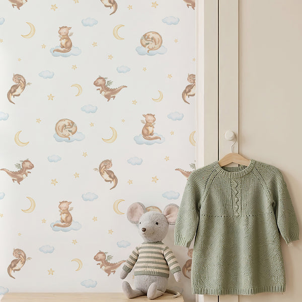 Fairytale nursery wallpaper with an adorable beige dragon, pale blue watercolor clouds and golden stars for a magical baby boy bedroom.