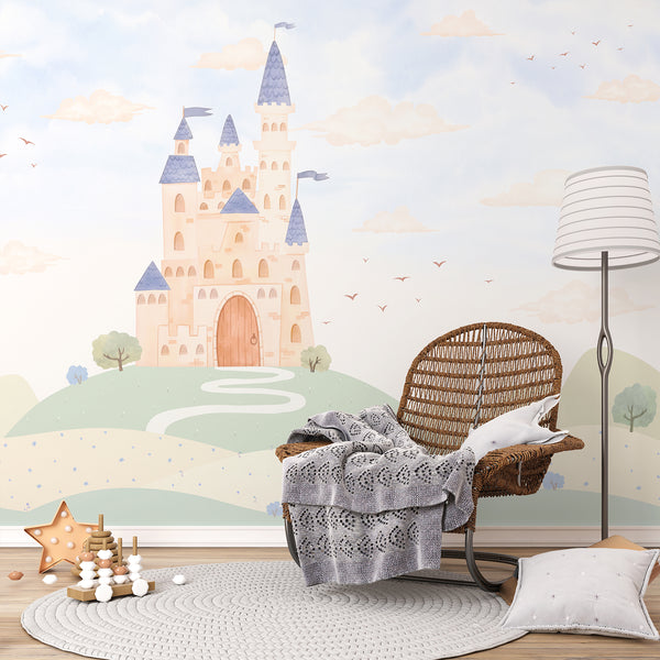 Storybook castle wallpaper mural featuring pastel blue towers, a winding path, rolling sage green hills and clouds for a whimsical children's room.