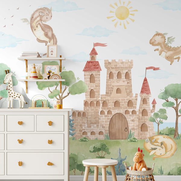 Kids room wall mural featuring a large watercolor castle surrounded by friendly dragons, green woodland trees, mountains, clouds and a yellow sun.