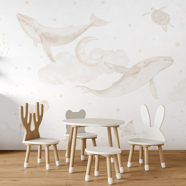 Neutral whale nursery wallpaper featuring beige watercolor humpback whales, sea turtles, whale shark, stingray, fish, clouds, moon and stars.