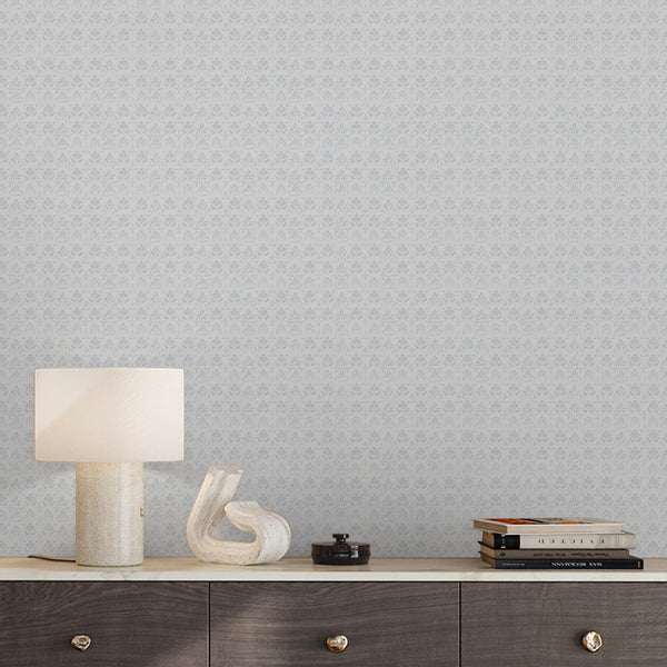 Dusty blue vintage damask wallpaper with a delicate repeating floral design and distressed texture for bedroom, hallway or powder room wall decor.