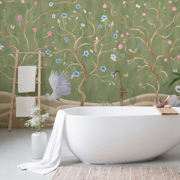 Heron bird wall mural featuring white wading birds, pink and blue blossoms, winding trees and butterflies on a muted green background.