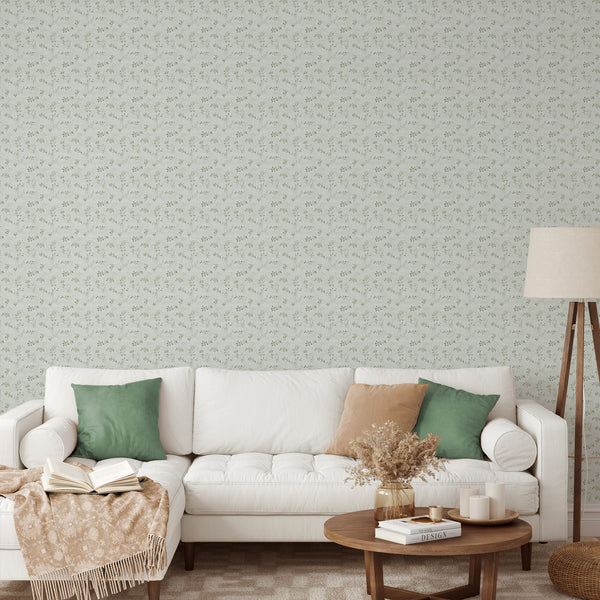 Sage green vine wallpaper with delicate vine sprigs and tiny leaf clusters on a pale ground with a linen texture. The petite scale creates a cozy, airy look, ideal for bedrooms or dining rooms. This removable peel and stick wallpaper is eco-friendly, made in the USA, and ideal for renters seeking a soft botanical design.