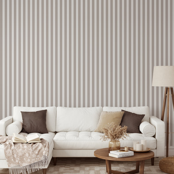 Neutral taupe wallpaper featuring alternating white stripes and delicate vertical lines for a minimalist bedroom accent wall or modern living room.