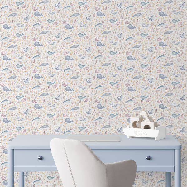 Coastal nursery wallpaper featuring a large blue whale, delicate coral, starfish, pearl shells, fish, and sea plants in a playful underwater pattern.
