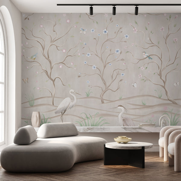 Vintage botanical wallpaper with herons, small birds, butterflies and graceful flowering branches in muted beige, pink, blue and green watercolor tones.
