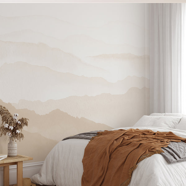 Watercolor mountain wallpaper in light beige and warm neutral tones features layered abstract hills for a modern living room, bedroom or home office wall.